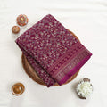 Art Silk saree with delicate floral vine print and zari border in purple top view folded display