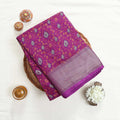 Art silk saree with floral vine jaal pattern and silver zari striped border in purple folded top view display