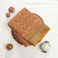 Art Silk saree with delicate floral vine print and zari border in yellow top view folded display