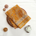 Art silk saree with floral vine and paisley motifs in yellow folded flat lay product view