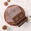 Kanchi Cotton Saree With Brown Zari Border And Subtle Motifs In Beige Neatly Folded Top View Display
