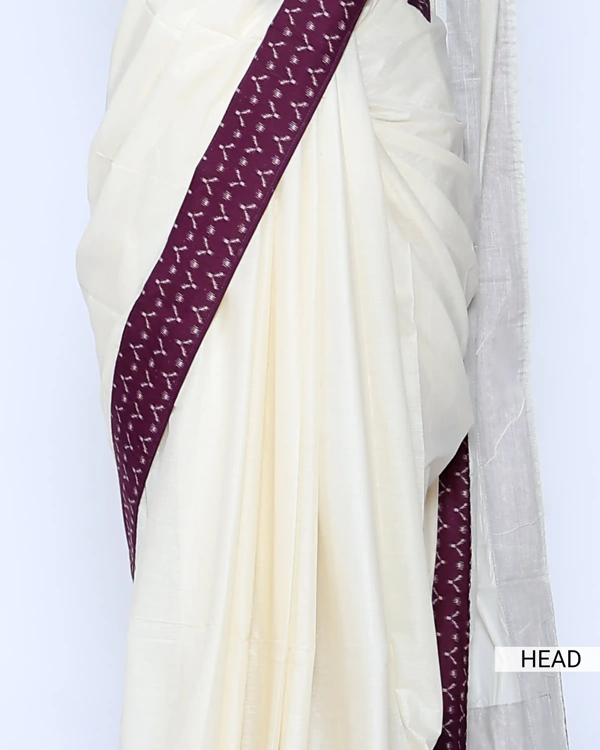 An off-white/cream saree featuring a deep purple border with a white geometric pattern - head view
