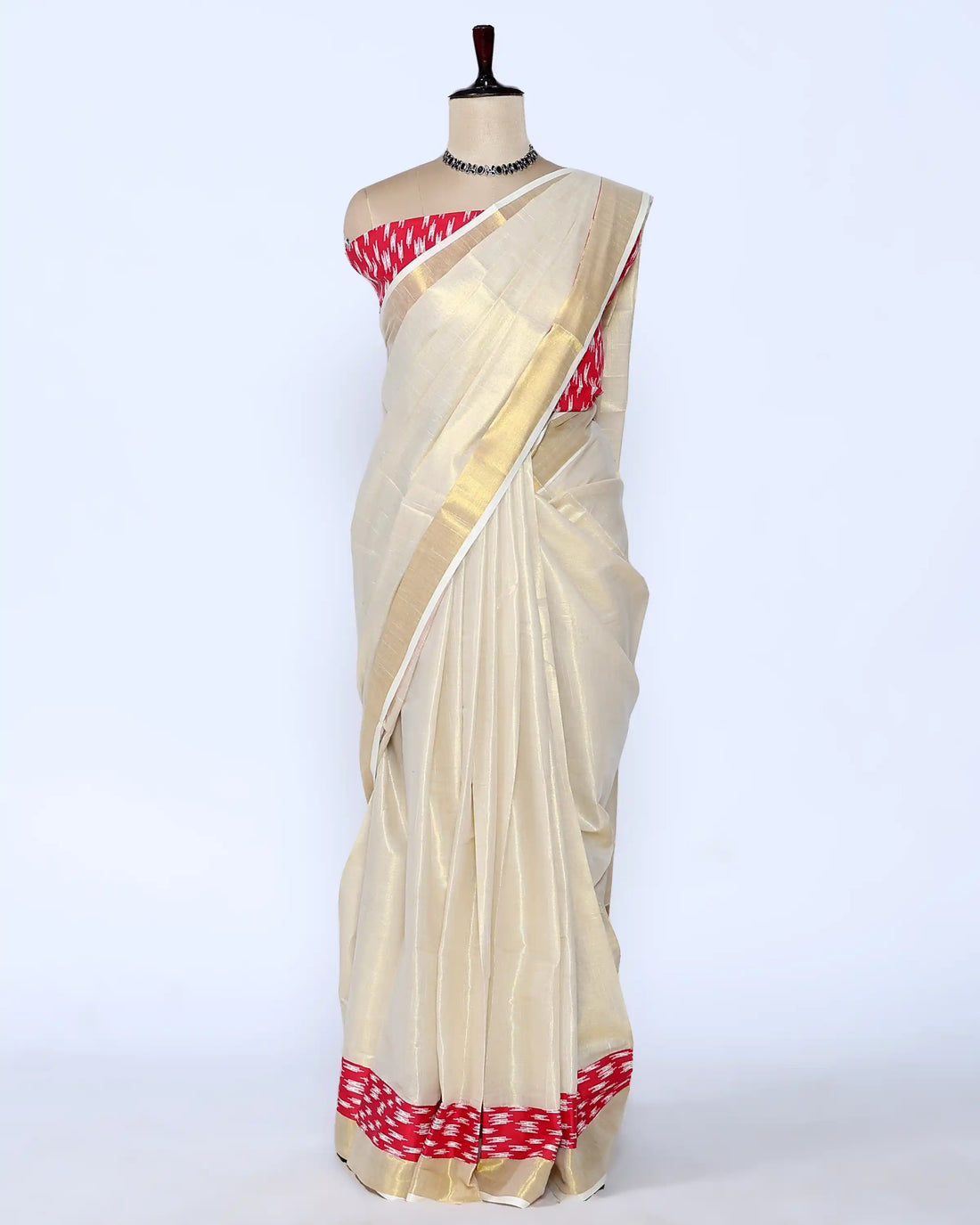 A cream-colored kerala saree with a red and white patterned border and matching blouse - full view