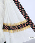 White cotton saree with black printed border and matching printed blouse - pallu view