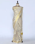 A cream-colored kerala saree with gold zari stripes and small colorful floral motifs, full view