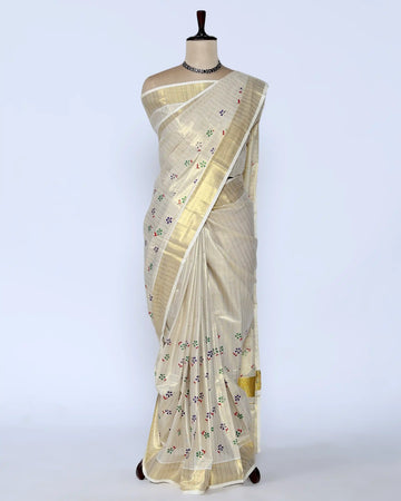 A cream-colored kerala saree with gold zari stripes and small colorful floral motifs, full view