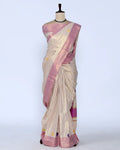 A cream and pink striped kerala saree with a matching pink blouse full view