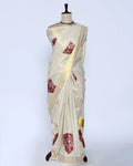 A cream-colored kerala saree with red print full view
