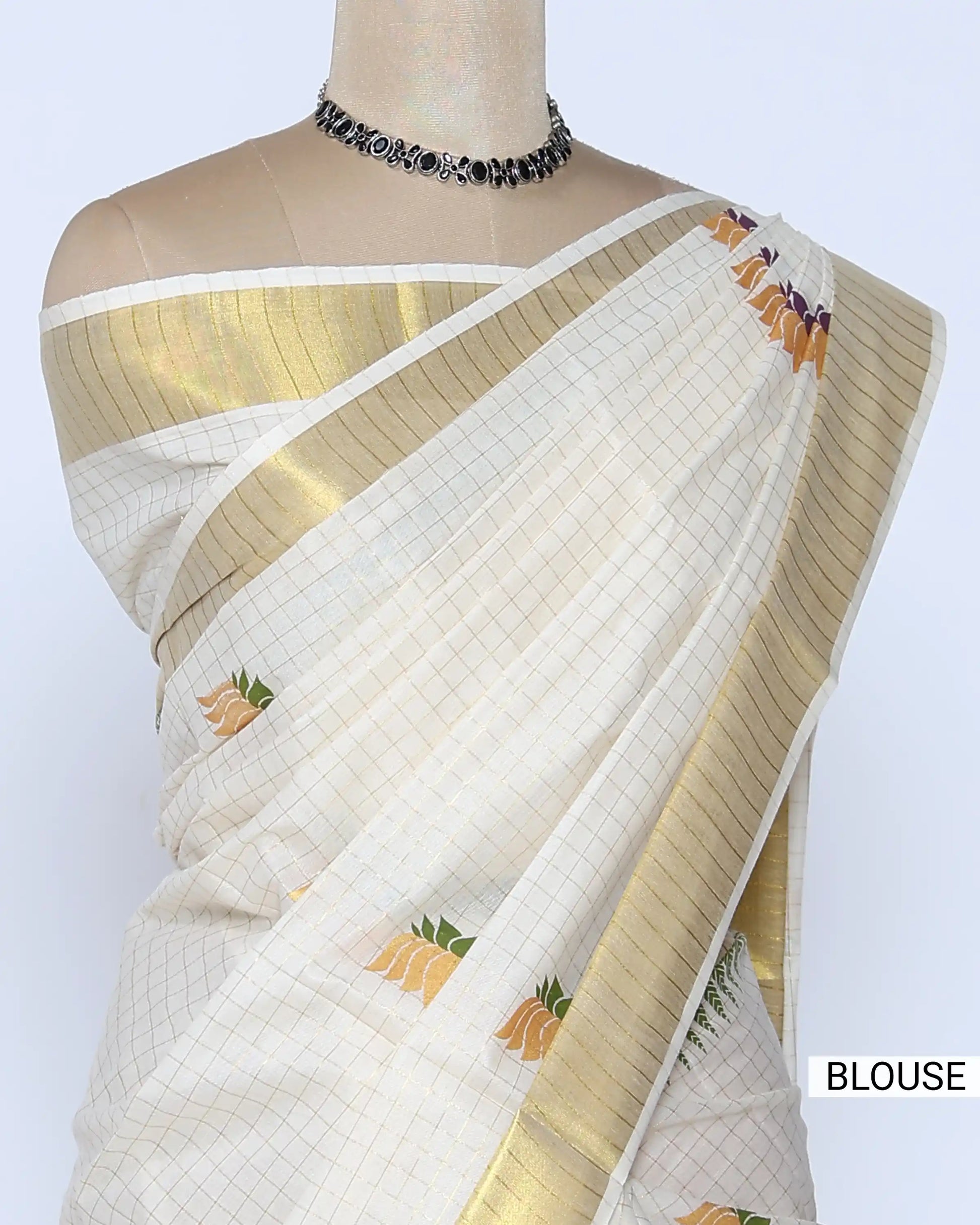 An off-white kerala saree with gold zari borders and small multicolor floral motifs - blouse view