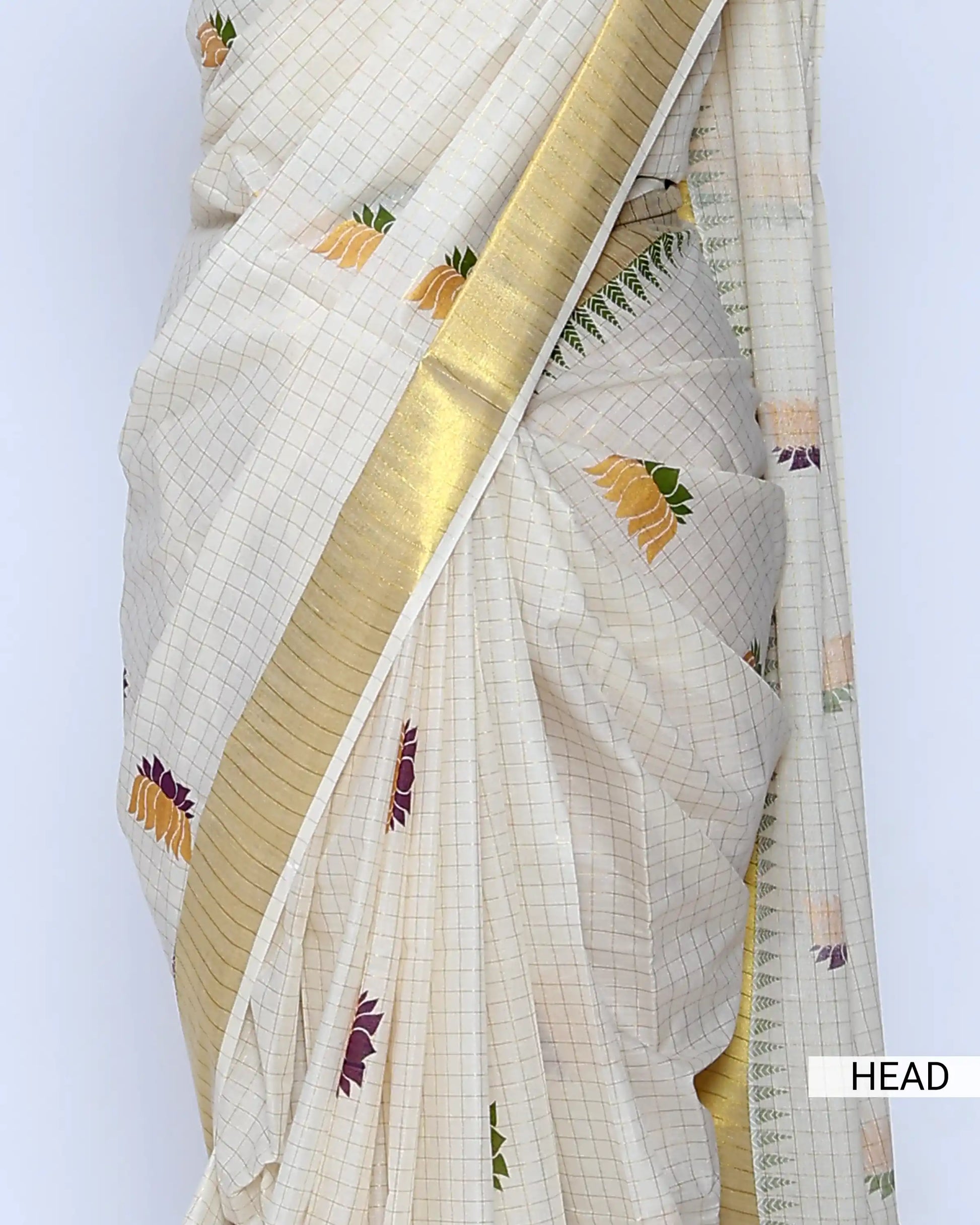 An off-white kerala saree with gold zari borders and small multicolor floral motifs - head view