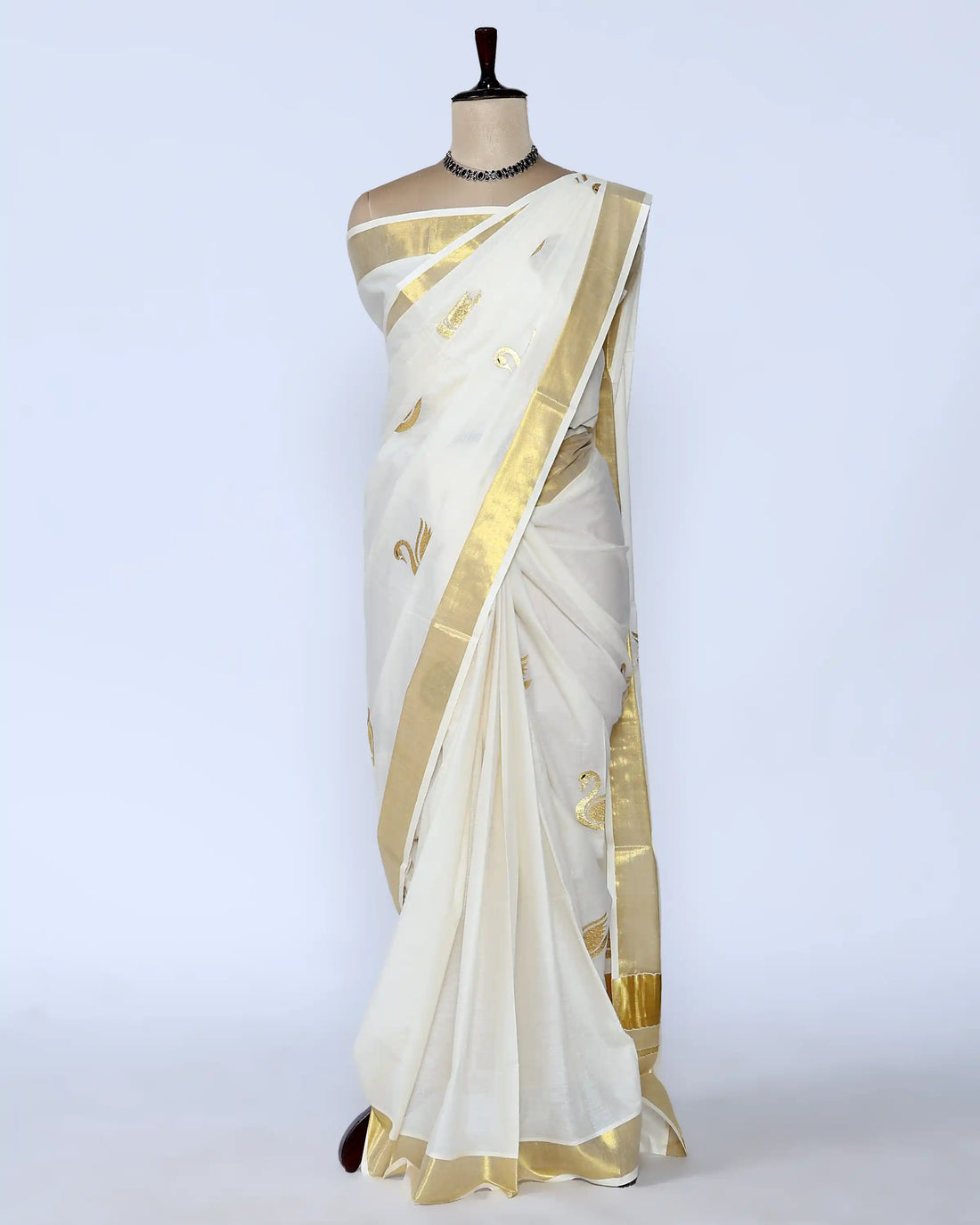 An off-white kerala saree with gold zari embroidery and borders - full view