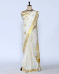 An off-white kerala saree with gold zari embroidery and borders - full view