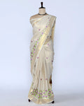 A cream-colored Kerala saree with purple and green floral embroidery full view