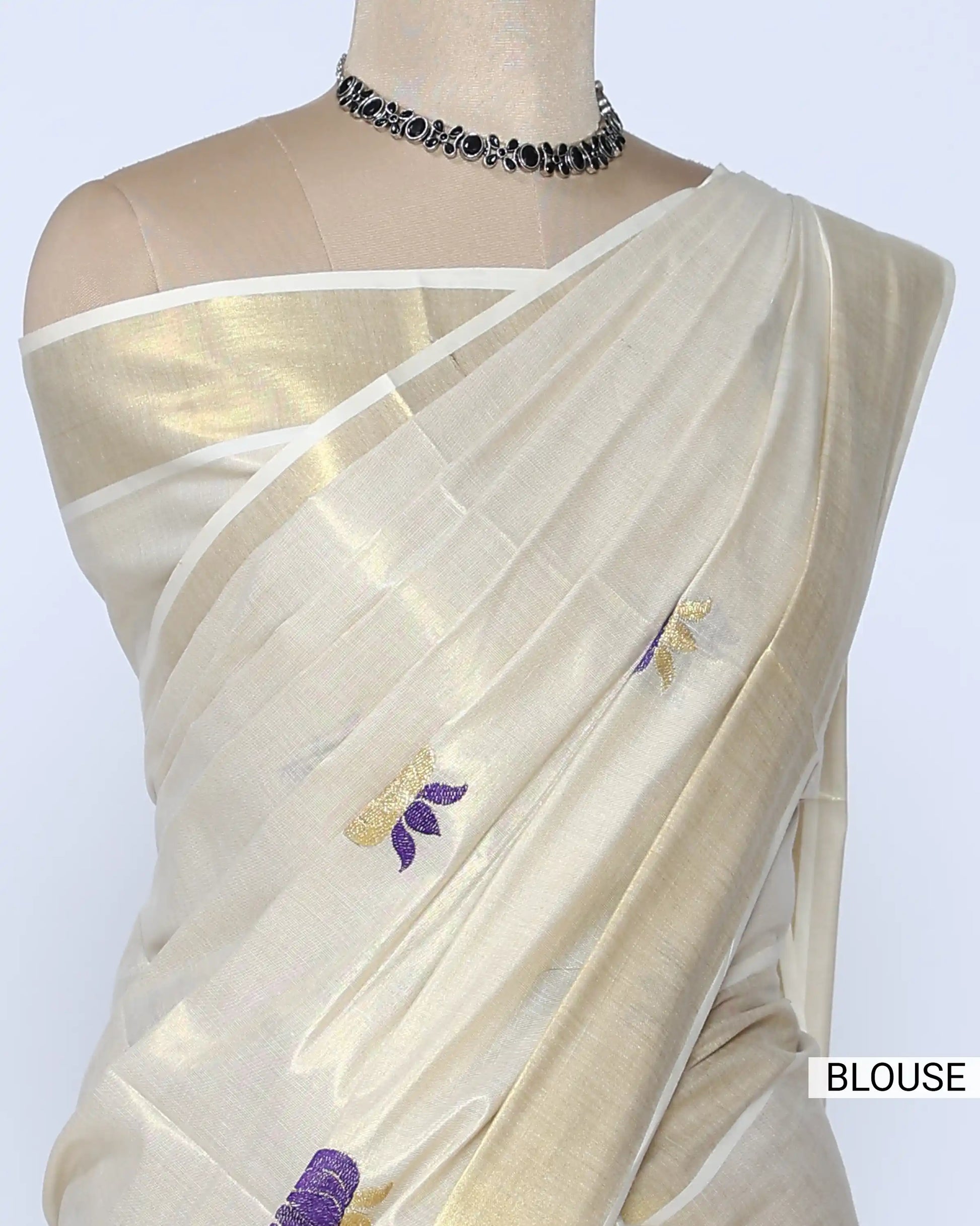 A cream-colored silk saree with small purple and gold floral motifs - blouse view