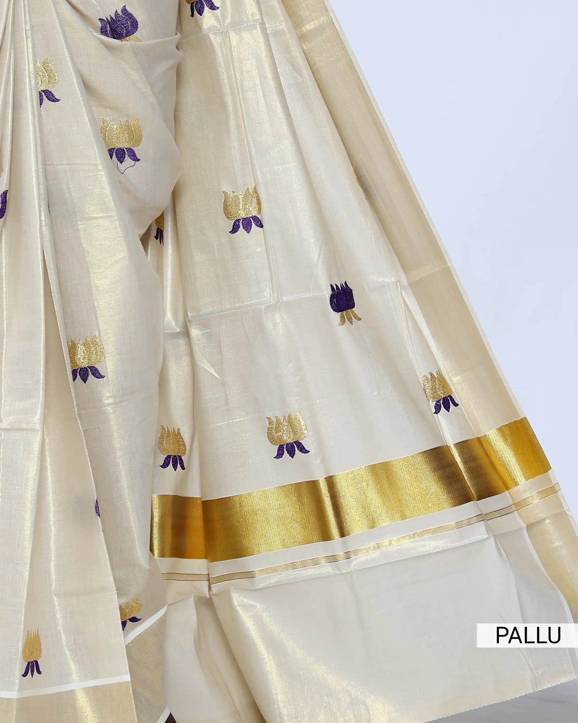 A cream-colored silk saree with small purple and gold floral motifs - pallu view