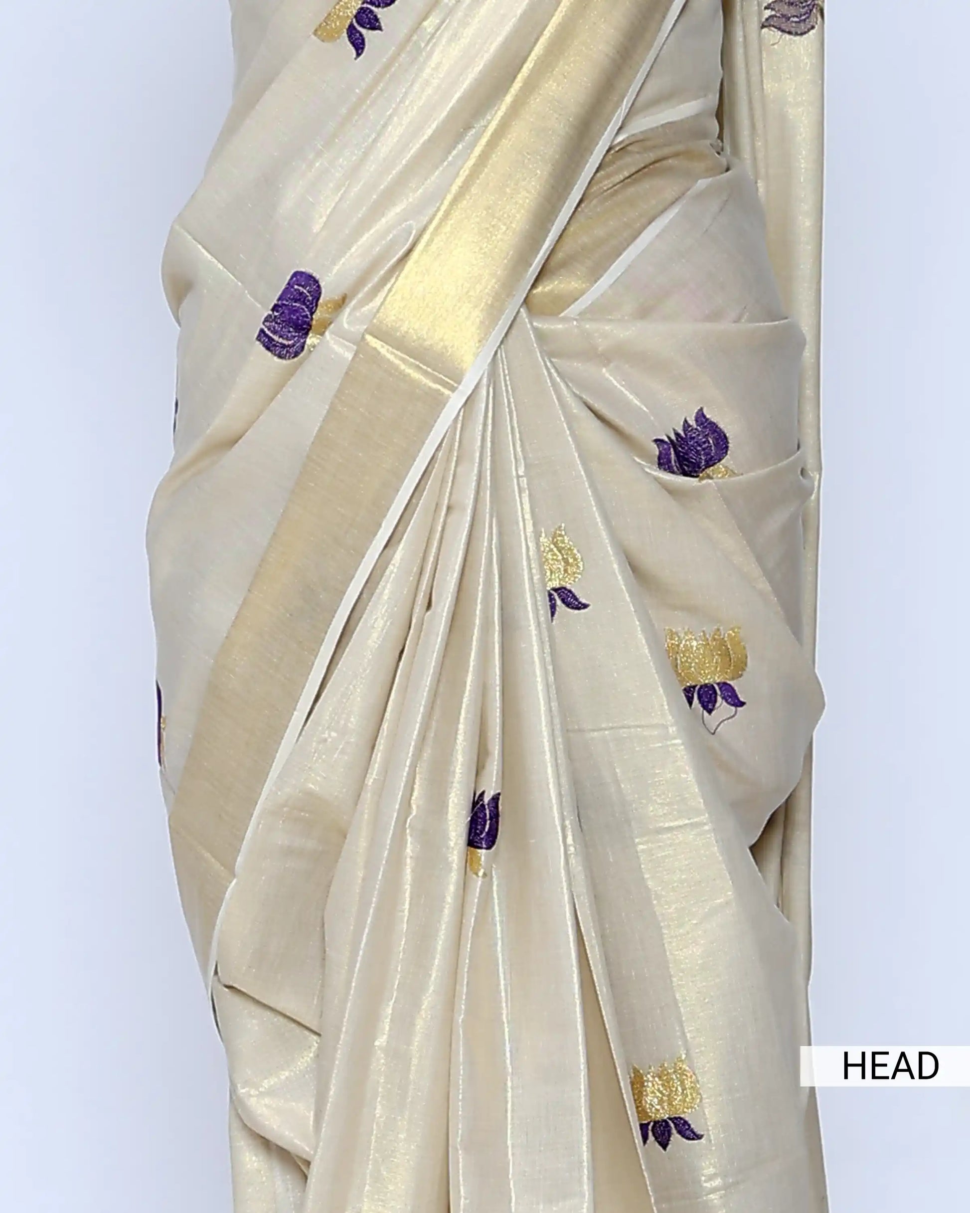 A cream-colored silk saree with small purple and gold floral motifs - head view