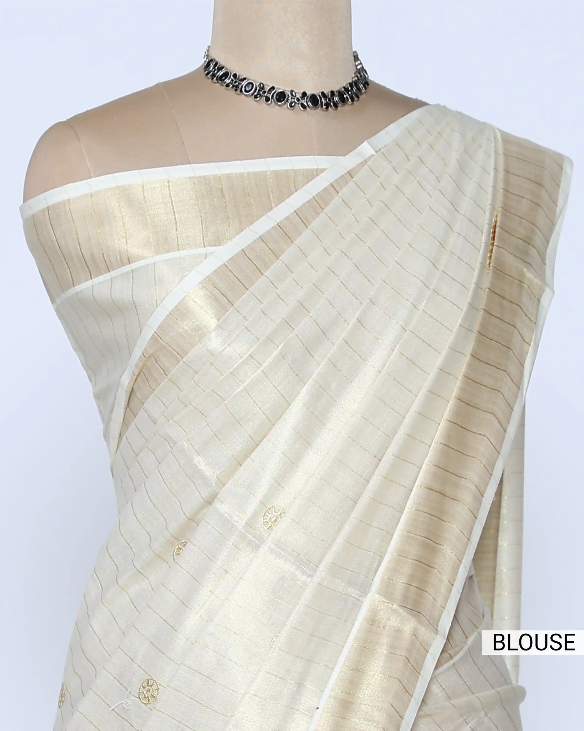 A cream-colored kerala saree with subtle stripes and colorful traditional prints on the border - blouse view