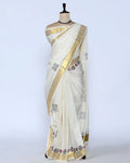 An off-white cotton saree with a wide gold border and small black and red floral motifs - full view