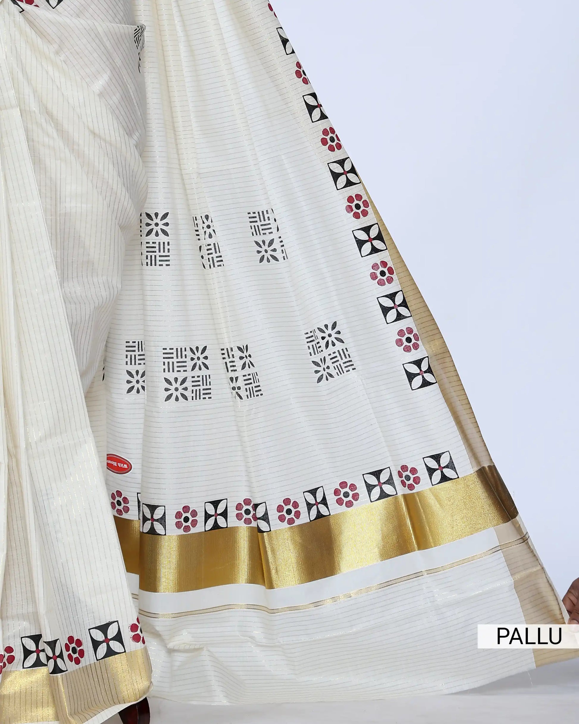 An off-white cotton saree with a wide gold border and small black and red floral motifs - pallu view