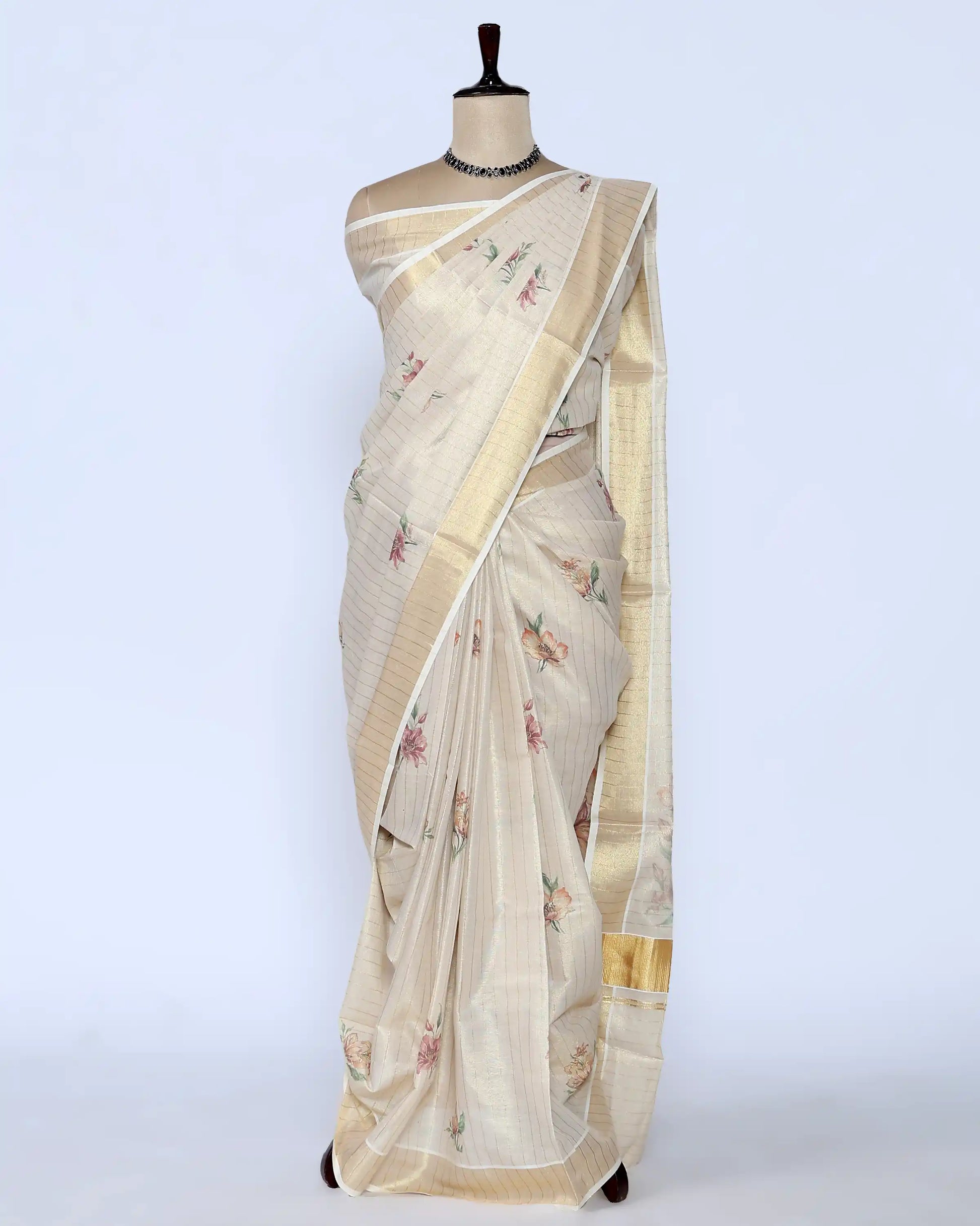 A cream-colored kerala saree with delicate floral prints and a gold border - full view