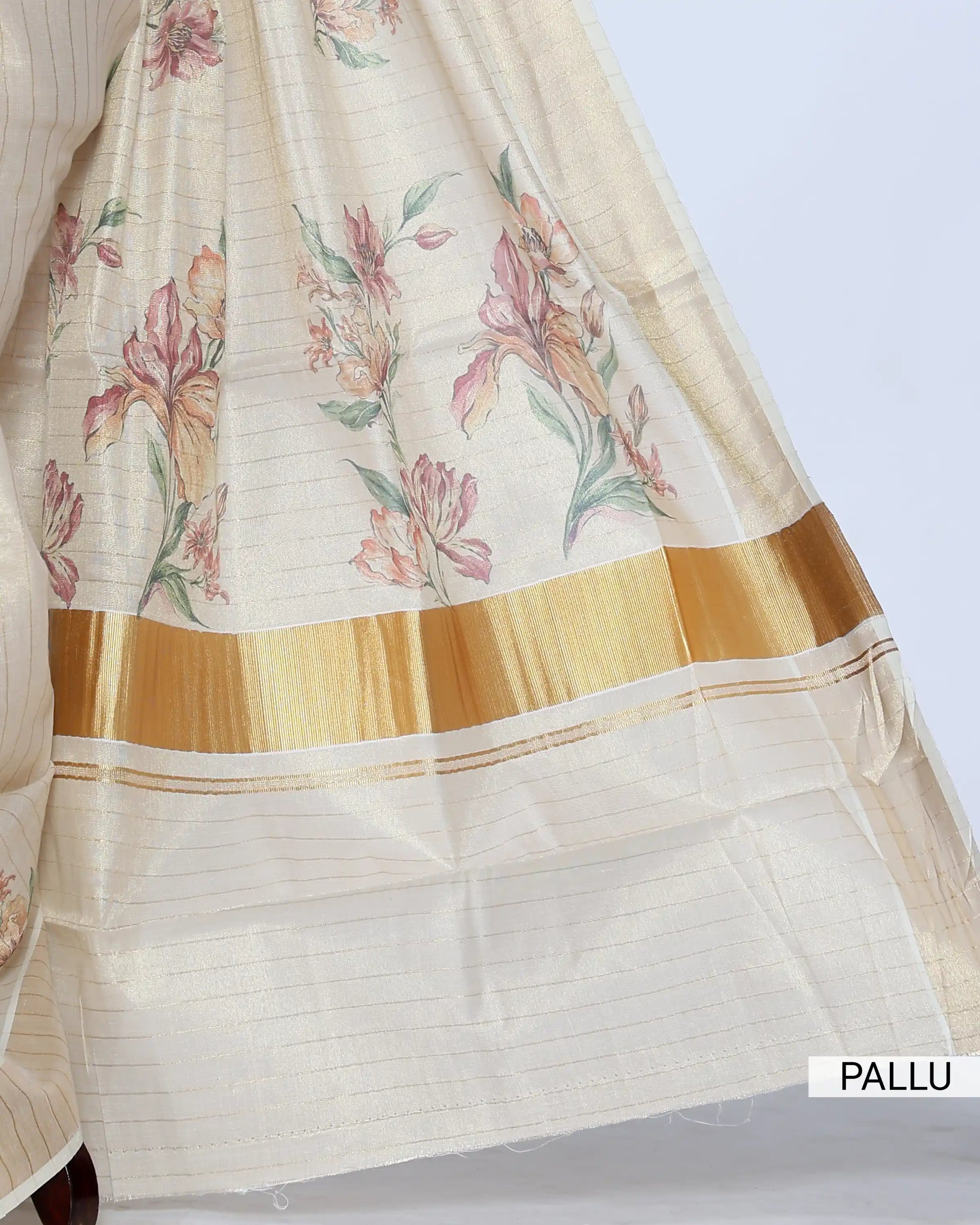 A cream-colored kerala saree with delicate floral prints and a gold border - pallu view