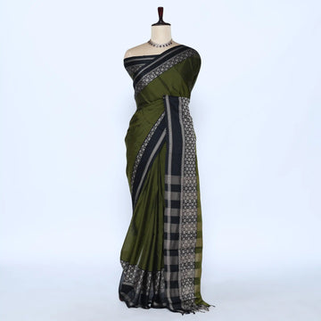 An dark green saree with black and silver patterned borders