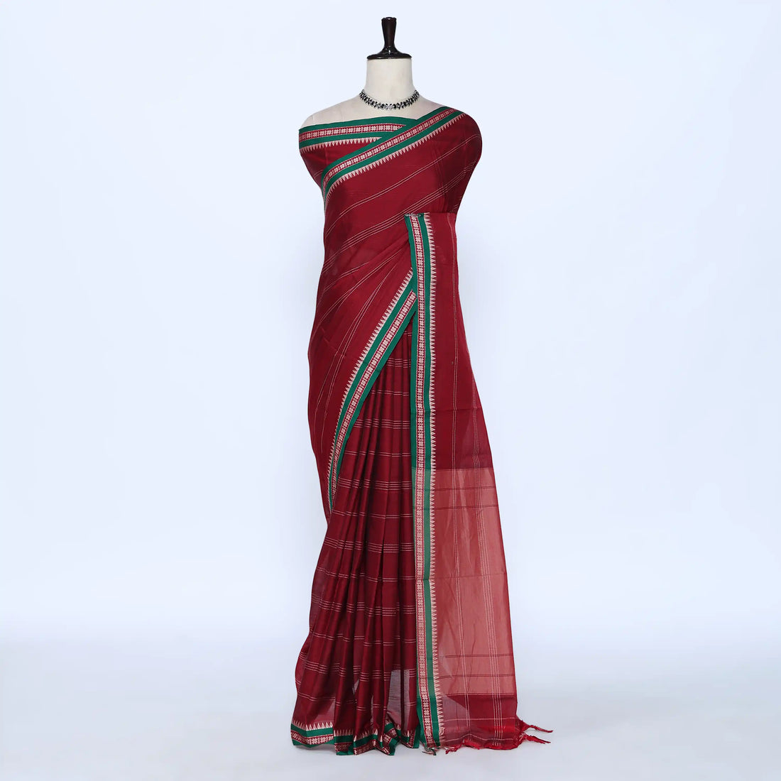 Deep red saree featuring green and gold woven striped border full view
