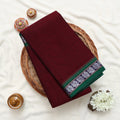 Narayanpet Cotton saree with deep purple body and silver zari woven border, folded top view