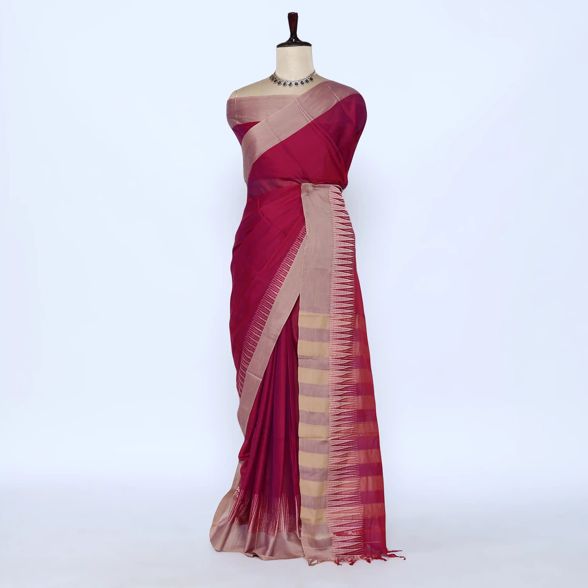 Deep magenta and beige striped saree detail showcasing woven texture and elegant striped pattern