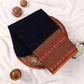 Kanchi Cotton Saree With Navy Blue Body And Gold Zari Border Folded Display On Wicker Tray Top View
