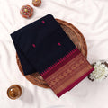 Kanchi Cotton Saree With Navy Blue Weave Pink Motifs And Gold Zari Border Folded Flat Lay Top View With Decor
