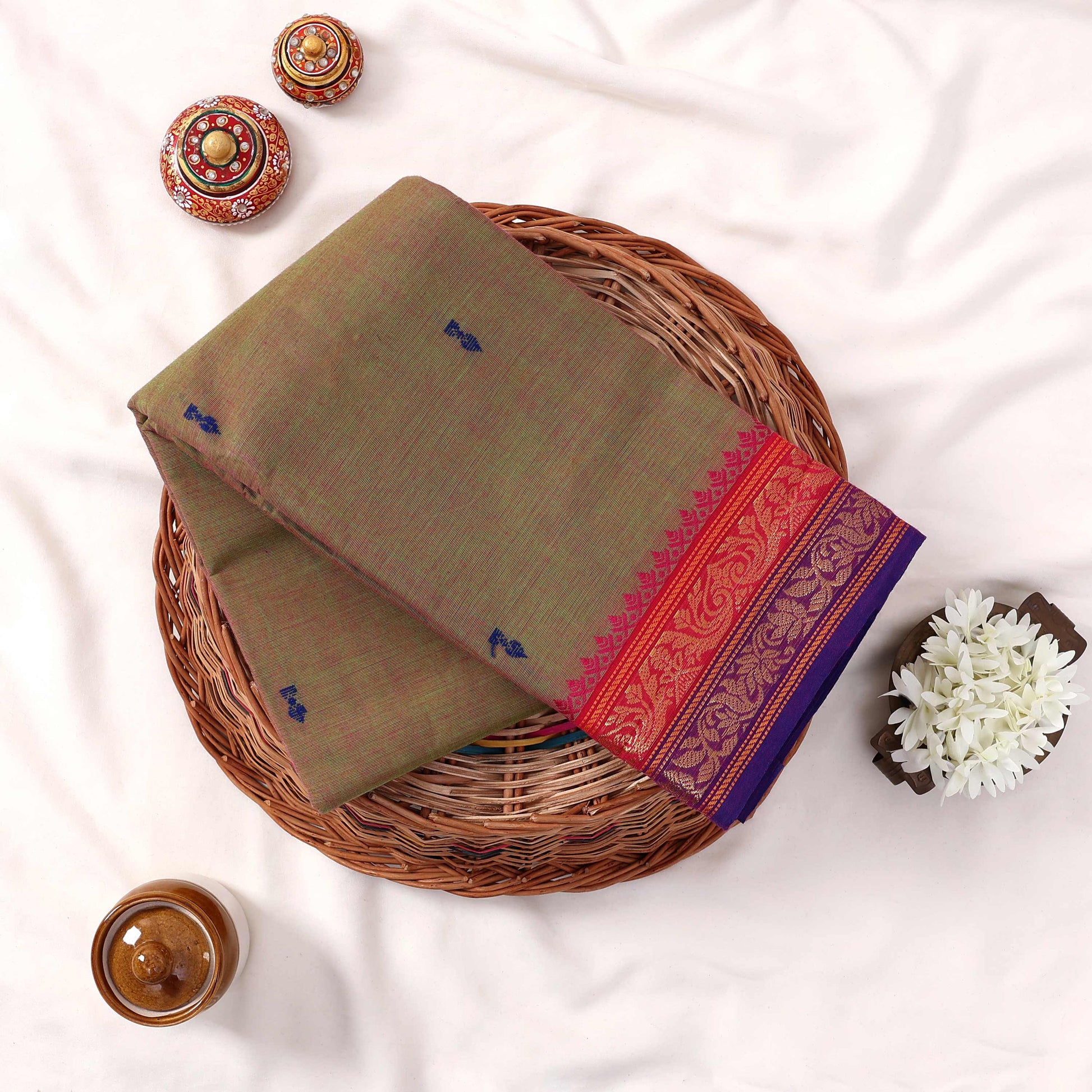 Kanchi Cotton Saree With Olive Green Body Pink Purple Zari Border And Woven Motifs Folded Flat Lay View
