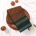 Kanchi Cotton Saree With Olive Green Body Dark Green Zari Border And Temple Design Folded Basket Top View
