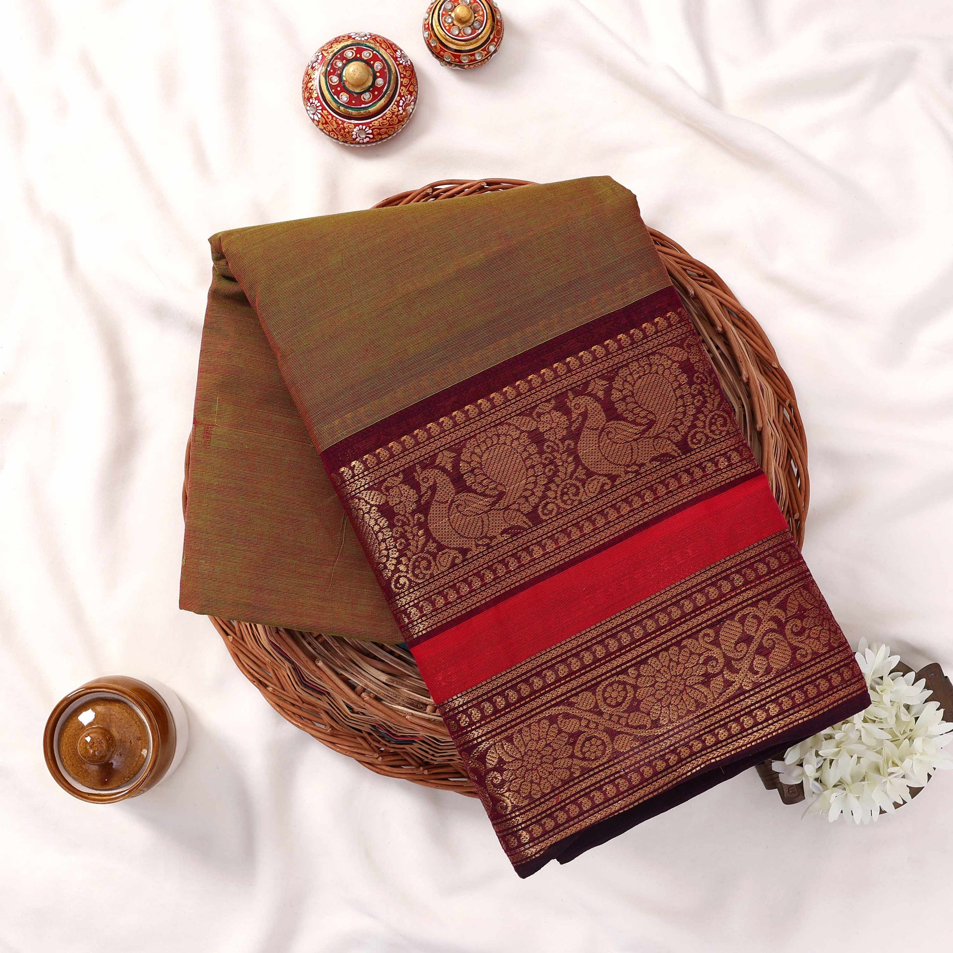 Kanchi Cotton Saree With Maroon And Gold Zari Peacock Border Red Accent Stripe And Olive Green Body Flat Lay Top View

