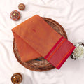 Traditional Kanchi Cotton Saree With Orange Body And Pink Zari Pallu Flat Lay Product Display
