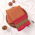 Kanchi Cotton Saree With Orange Toned Woven Body And Pink Zari Border Folded Flat Lay Product View
