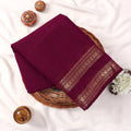 Kanchi Cotton Saree With Gold Zari Border In Deep Purple Neatly Folded In Basket Top View Display
