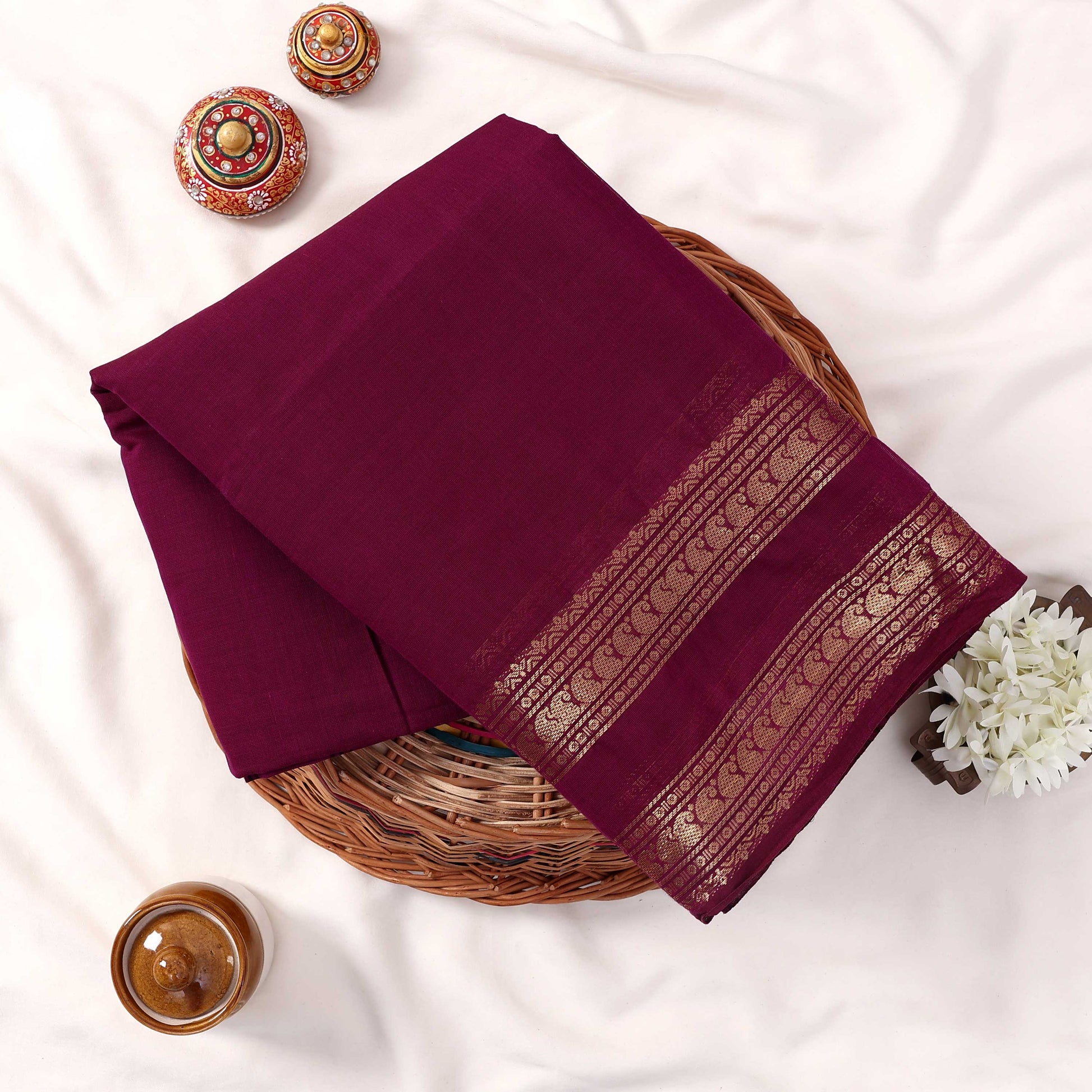 Kanchi Cotton Saree With Gold Zari Border In Deep Purple Neatly Folded In Basket Top View Display
