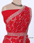Red off-the-shoulder blouse with intricate silver floral embroidery and a matching waistband