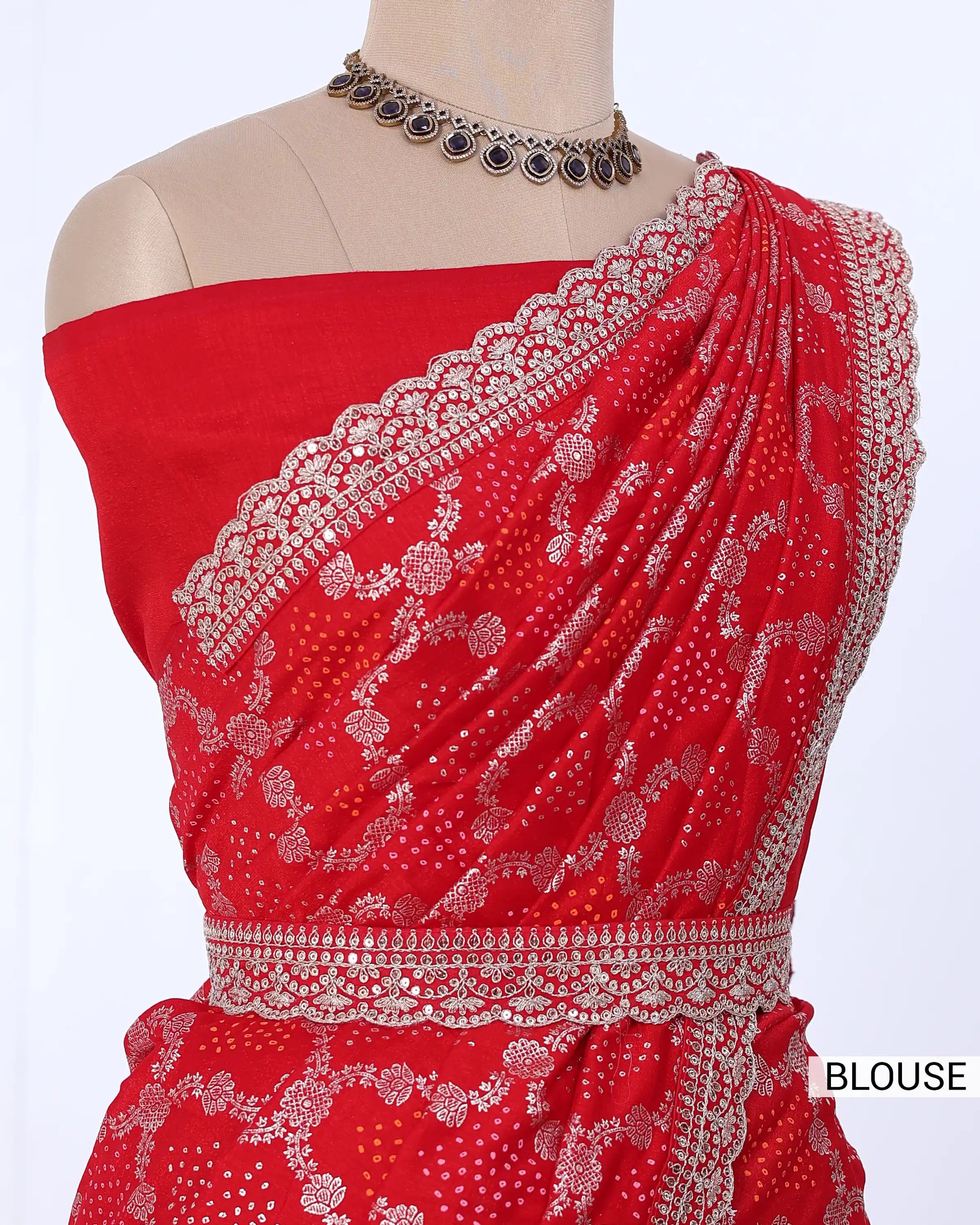 Red off-the-shoulder blouse with intricate silver floral embroidery and a matching waistband