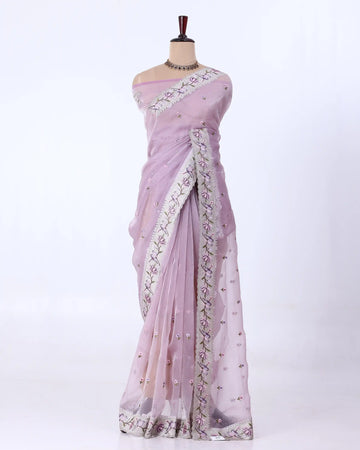 A light pink/lavender saree with silver floral embroidery and mirror work