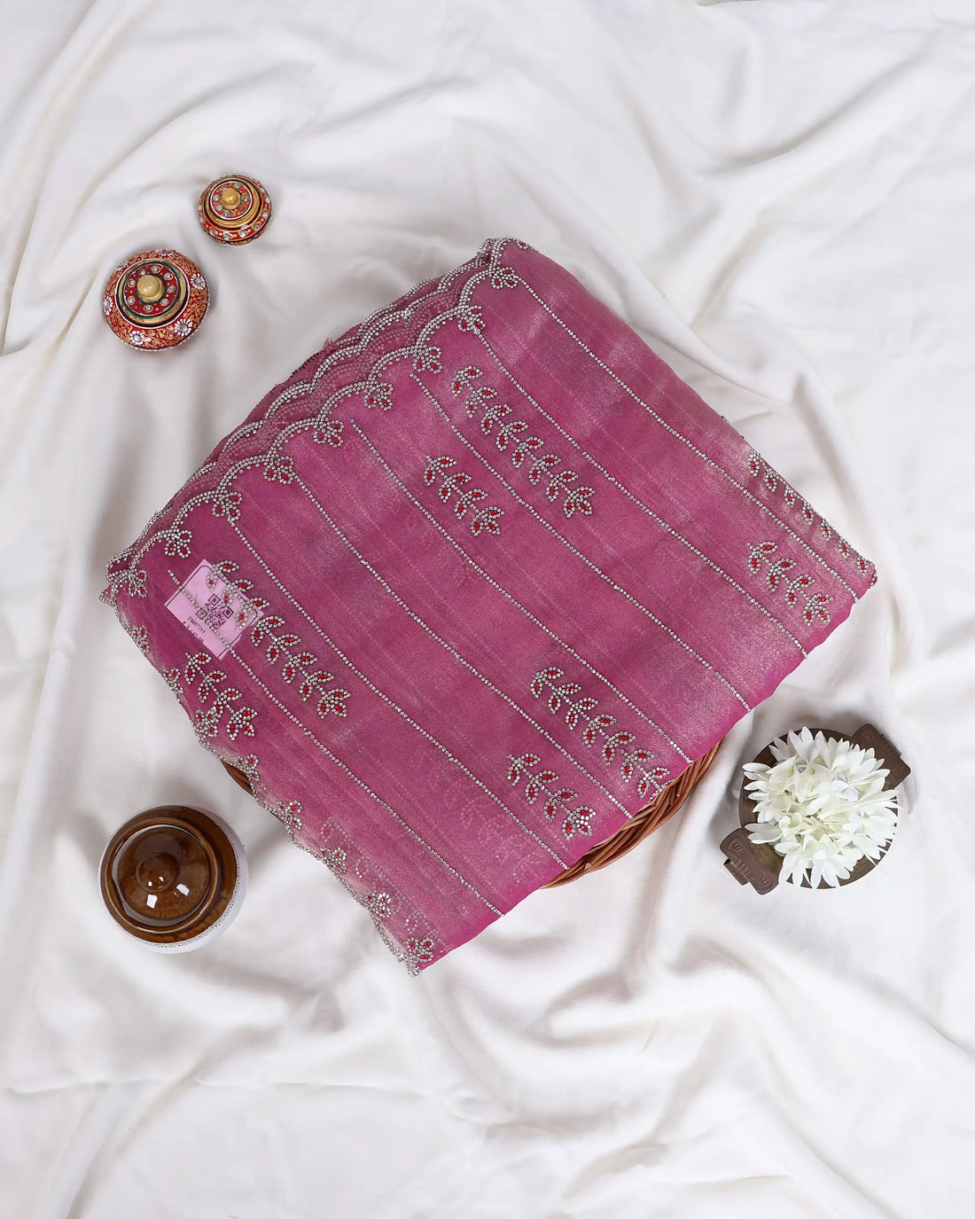 A pink saree with silver zari embroidery and also matching blouse