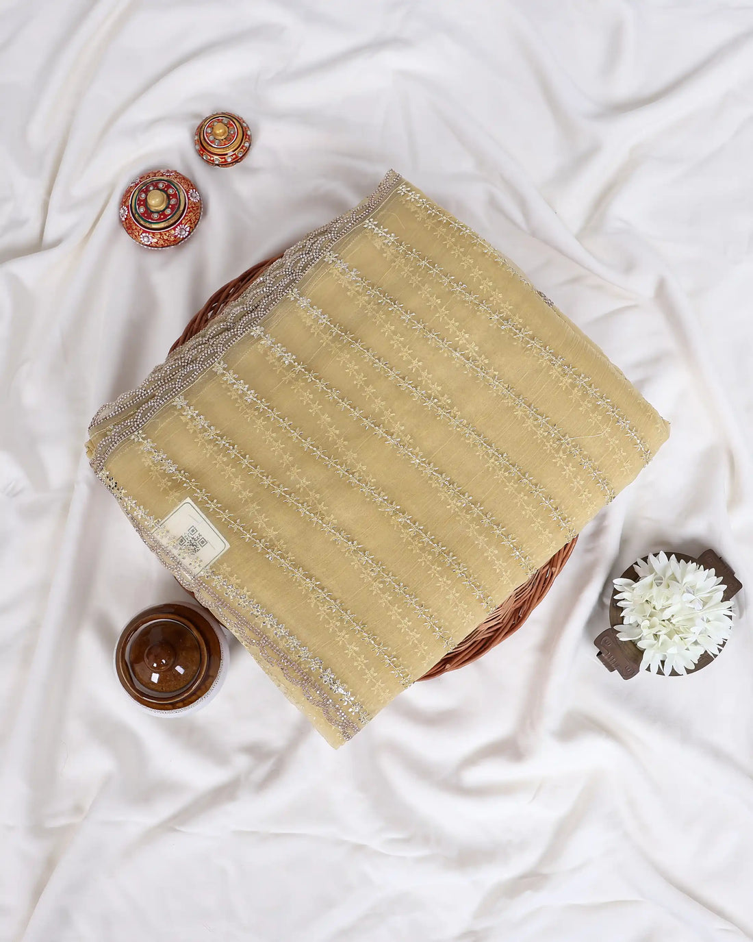 A pale yellow saree with silver mirror-work embroidery