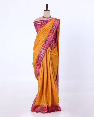 A yellow raw silk saree with a pink and magenta border