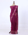 A deep magenta purple saree with floral and geometric patter