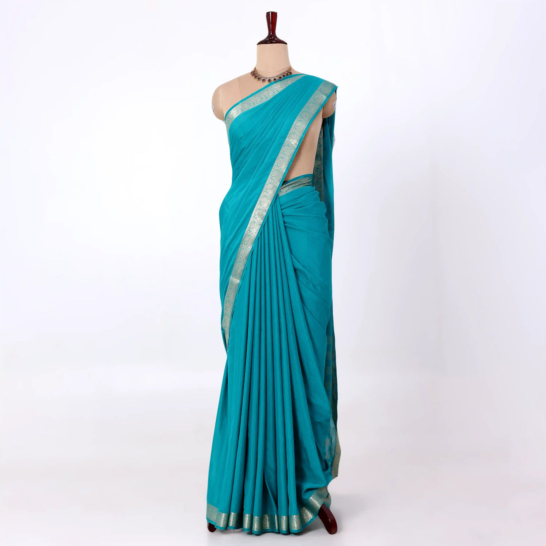Mysore Silk saree with plain turquoise blue body and silver zari woven border, front drape view