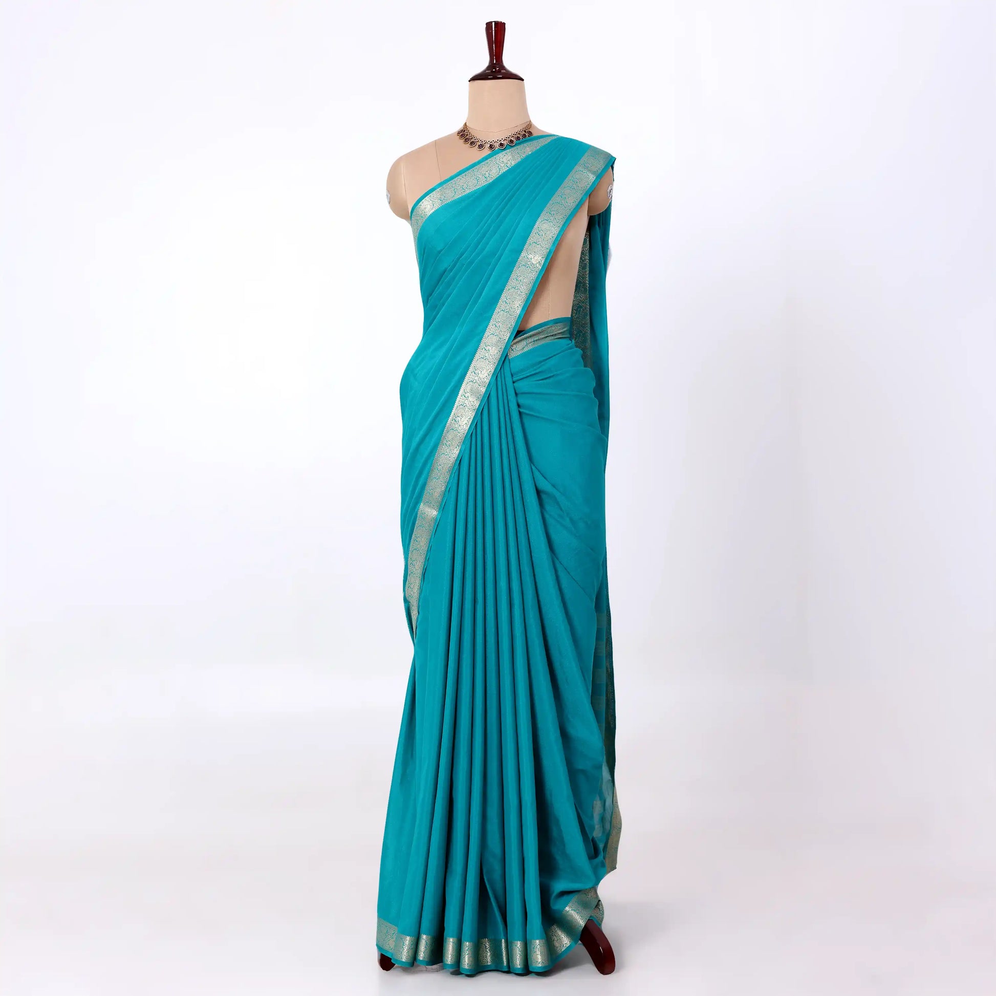 Mysore Silk saree with plain turquoise blue body and silver zari woven border, front drape view