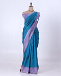 A teal blue and lavender purple silk saree with matching blouse