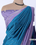 A blue and purple saree  featuring a pleated blue body with thin metallic stripes, a lavender purple border, and a matching lavender blouse. 