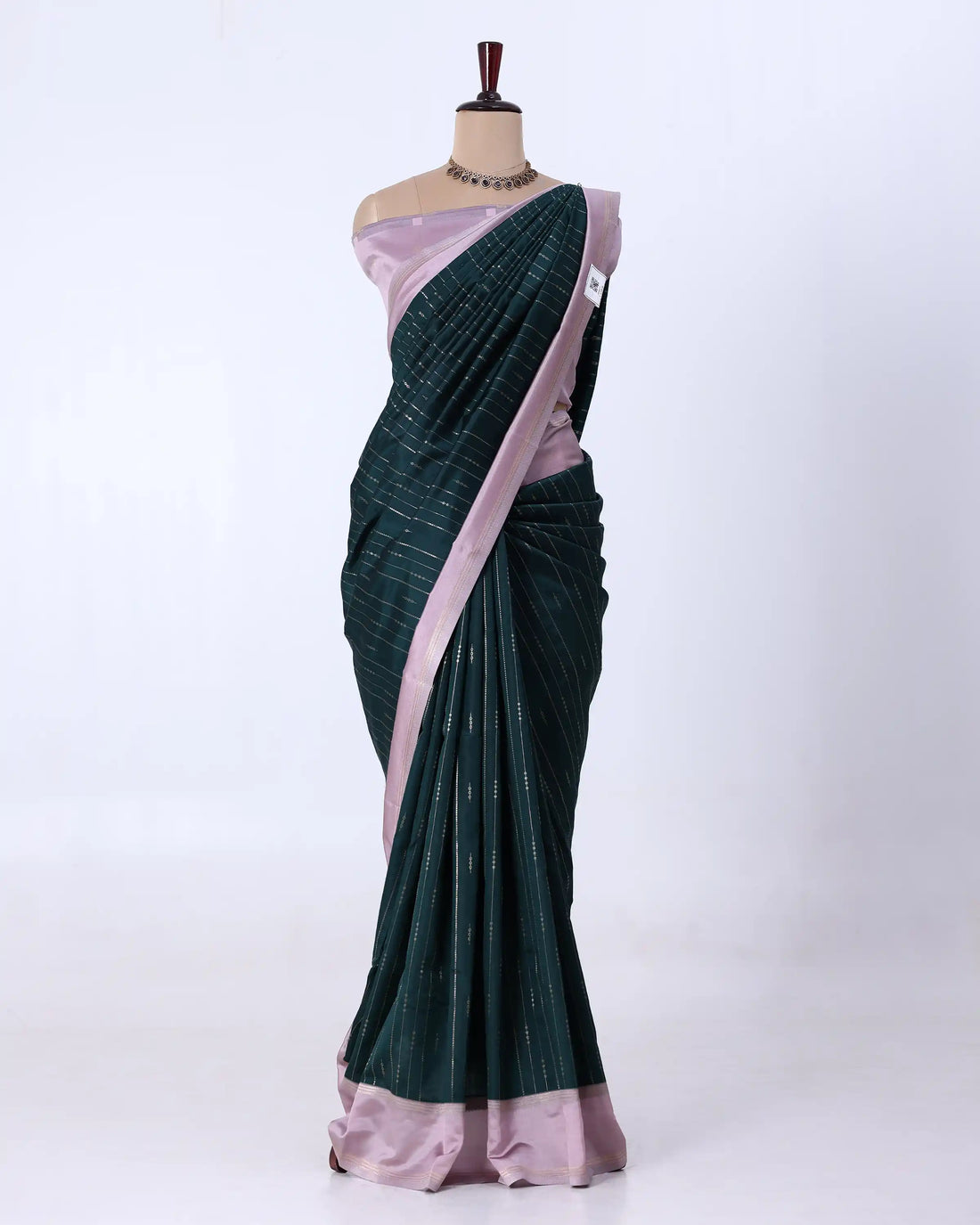 A lavender purple silk saree with a metallic gold border